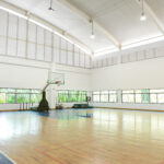GYMNASIUM PAINTING - Gymnasium painting involves the meticulous painting and decorating of gymnasiums, sports facilities, and fitness centers to create an environment that is vibrant, motivating for physical activity. The process begins with thorough surface preparation, including cleaning, repairing, and priming surfaces to ensure proper adhesion of the paint. Special attention is given to high-traffic areas and surfaces prone to wear and tear. PCommercialpainting.com uses high-quality, durable paints that can withstand the rigors of an active environment. Gymnasium painting requires precision, attention to detail, and the ability to work efficiently to minimize downtime for the facility. our goal is to create a visually appealing space that inspires and energizes athletes and fitness enthusiasts.